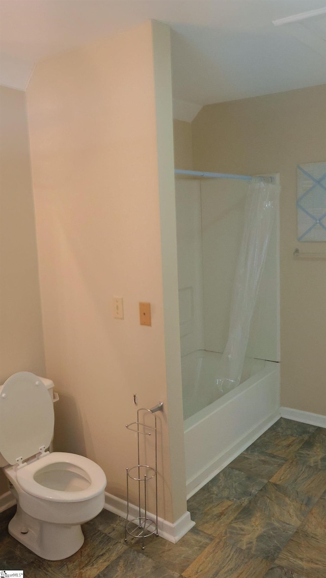 bathroom with shower / tub combo and toilet