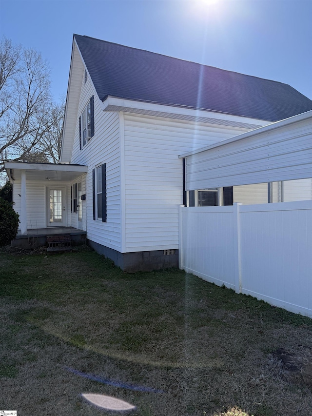 view of home's exterior with a yard and covered porch