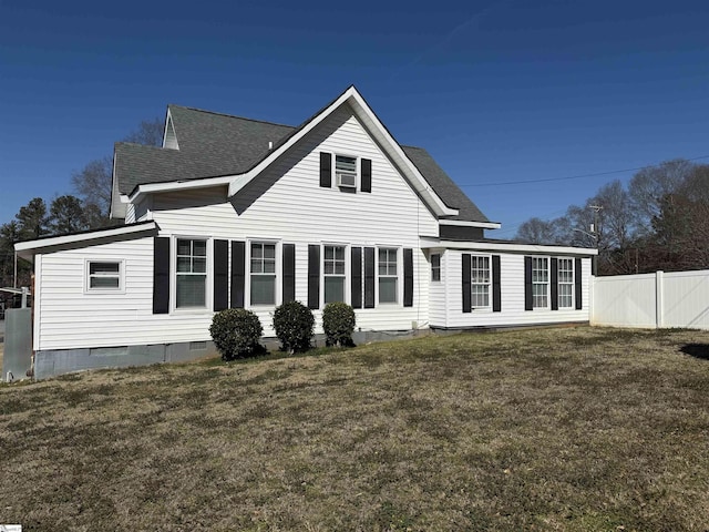 rear view of property featuring a yard