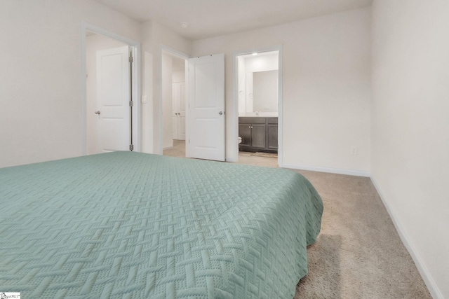 carpeted bedroom with connected bathroom