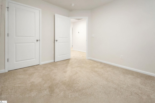 unfurnished bedroom with light colored carpet