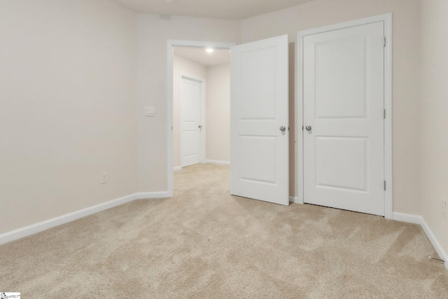 unfurnished bedroom with light carpet