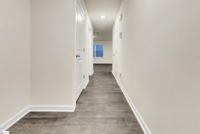 corridor with hardwood / wood-style floors