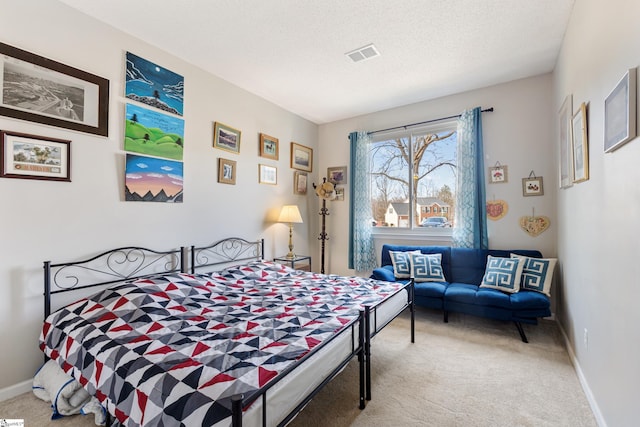 bedroom featuring carpet floors and a textured ceiling