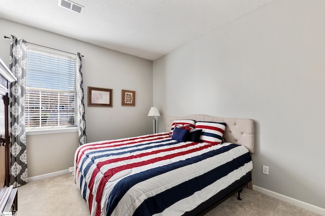 carpeted bedroom with a textured ceiling