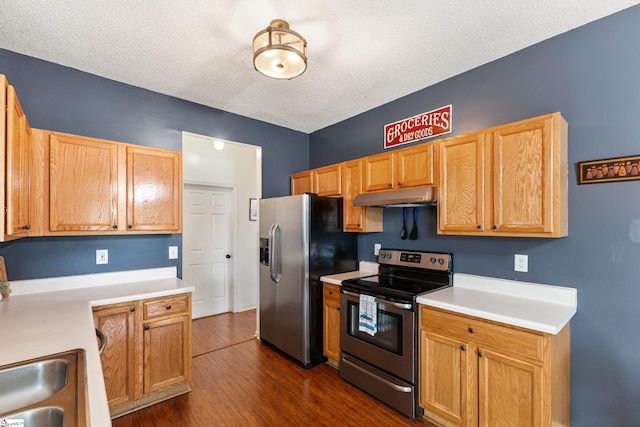 kitchen featuring stainless steel appliances, dark hardwood / wood-style flooring, and a textured ceiling