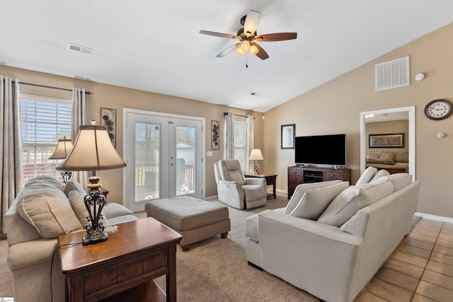 living room featuring french doors, ceiling fan, vaulted ceiling, and light tile patterned floors