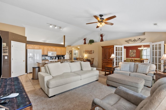 living room with light tile patterned floors, ceiling fan with notable chandelier, and vaulted ceiling