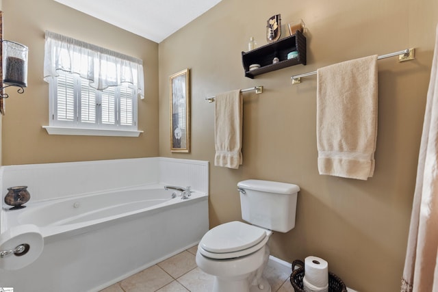 bathroom with tile patterned flooring, a bath, and toilet