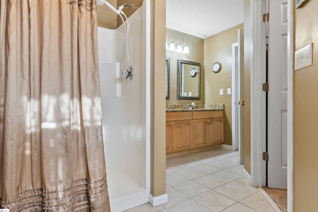 bathroom with vanity, curtained shower, and tile patterned floors