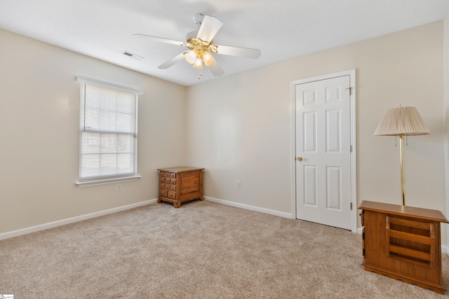 unfurnished bedroom with light carpet and ceiling fan