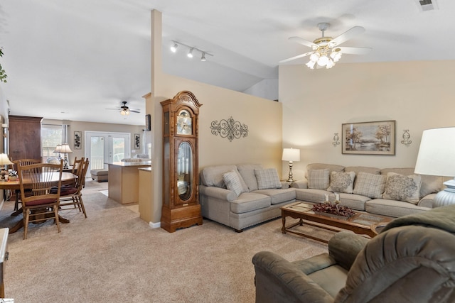 carpeted living room featuring lofted ceiling and ceiling fan