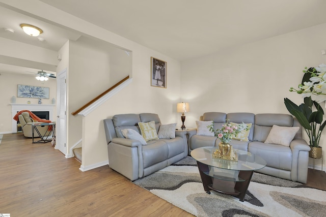 living room with ceiling fan and light hardwood / wood-style floors