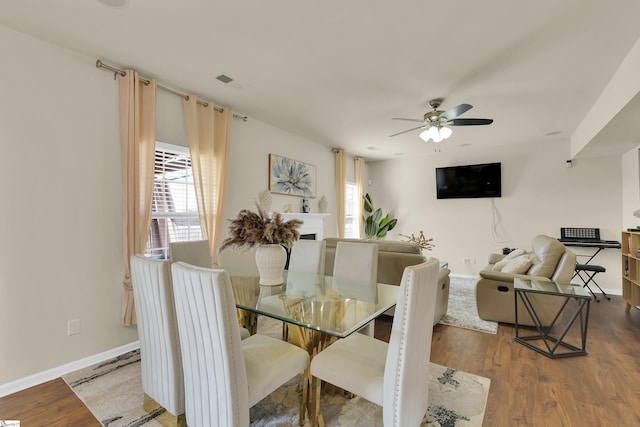 dining area with ceiling fan, plenty of natural light, and hardwood / wood-style floors