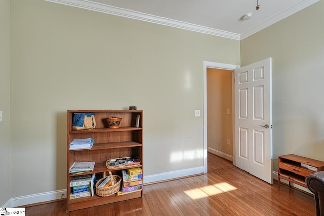 interior space featuring ornamental molding and light wood-type flooring