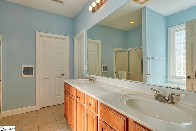 bathroom featuring vanity, tile patterned floors, and a shower with shower door