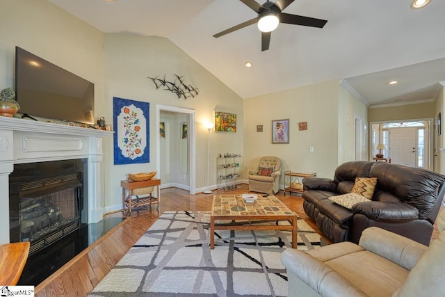 living room with vaulted ceiling, ceiling fan, crown molding, and light hardwood / wood-style flooring