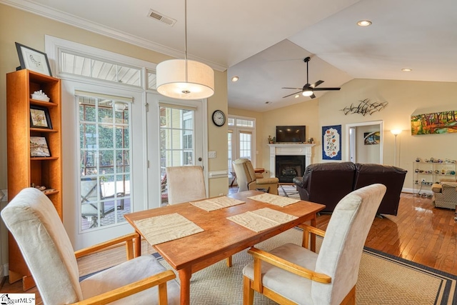 dining area with hardwood / wood-style floors, a wealth of natural light, vaulted ceiling, and ceiling fan