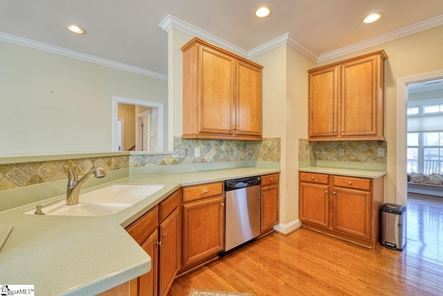 kitchen with sink, backsplash, ornamental molding, stainless steel dishwasher, and light hardwood / wood-style floors