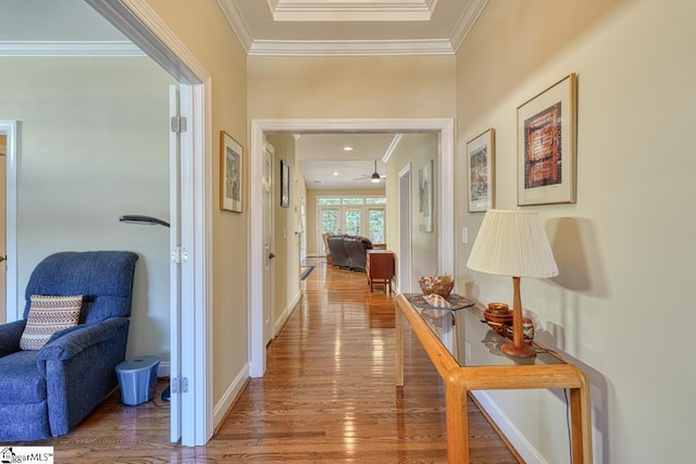 corridor with crown molding and hardwood / wood-style floors