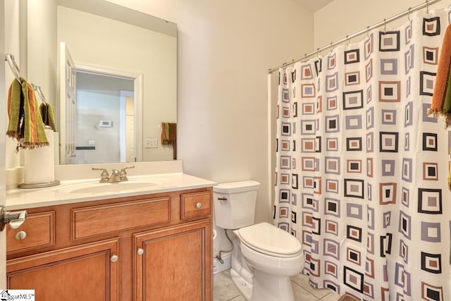 bathroom with a shower with curtain, vanity, toilet, and tile patterned flooring