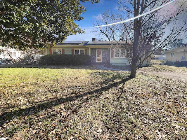 ranch-style house with a front yard and volleyball court