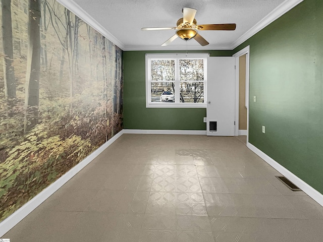 spare room with ceiling fan, ornamental molding, and a textured ceiling