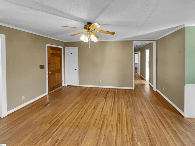 unfurnished room featuring ornamental molding, ceiling fan, a textured ceiling, and light wood-type flooring