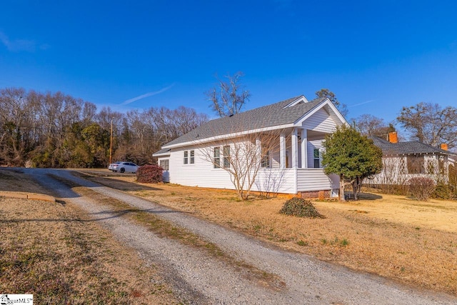 view of side of home featuring a lawn