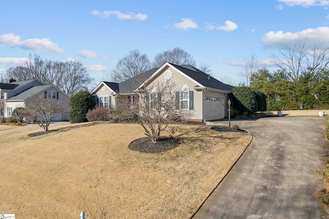 view of front of home with a garage and a front yard