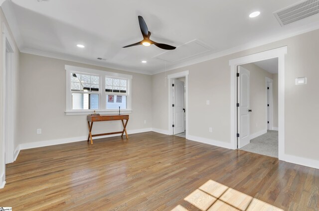 unfurnished living room with crown molding, hardwood / wood-style flooring, and ceiling fan