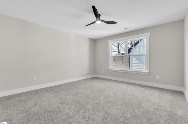 carpeted spare room with ceiling fan