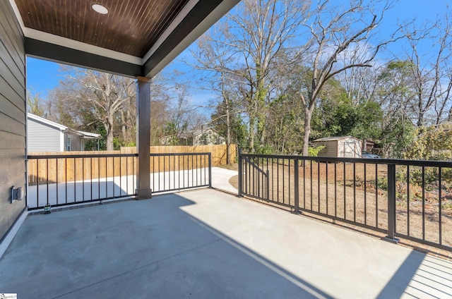 view of patio featuring a storage shed