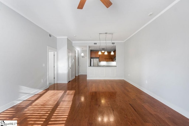 unfurnished living room featuring crown molding, ceiling fan, and dark hardwood / wood-style floors