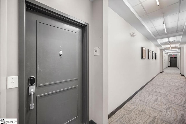 hallway featuring light colored carpet