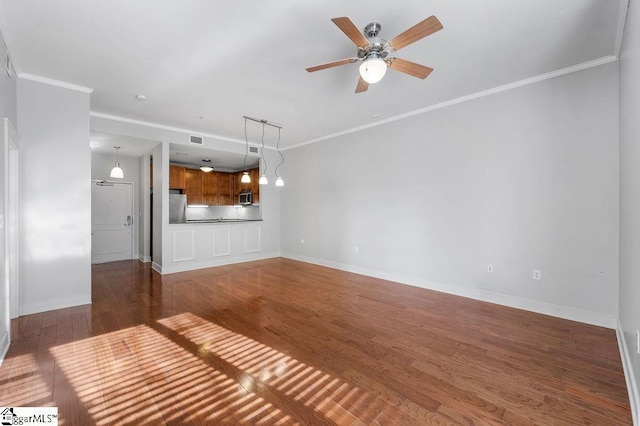 unfurnished living room featuring crown molding, ceiling fan, and dark hardwood / wood-style flooring