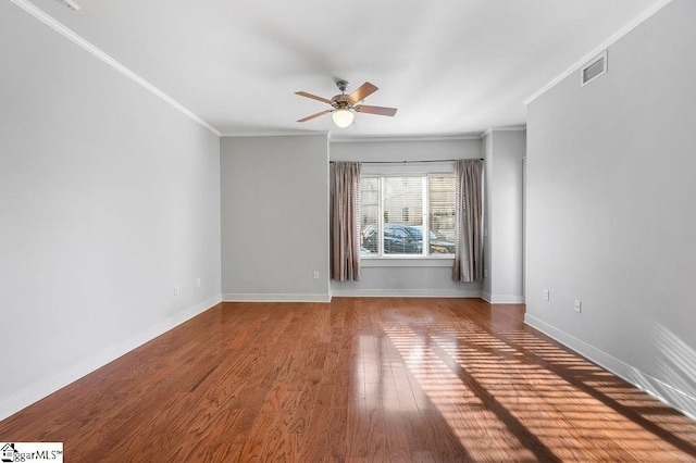 empty room with hardwood / wood-style flooring, ceiling fan, and ornamental molding