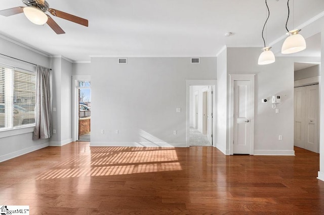 spare room with ornamental molding, ceiling fan, and dark hardwood / wood-style flooring