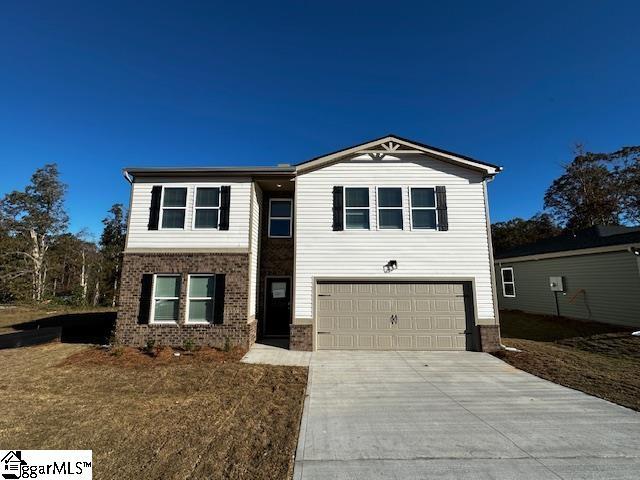 view of front of house with a garage and a front yard