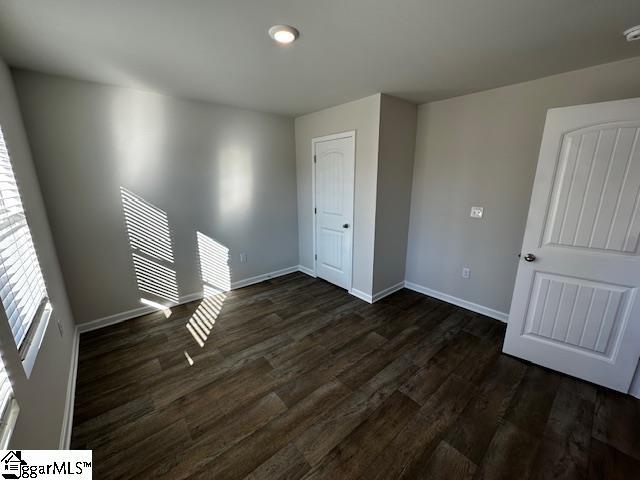 empty room featuring dark hardwood / wood-style flooring