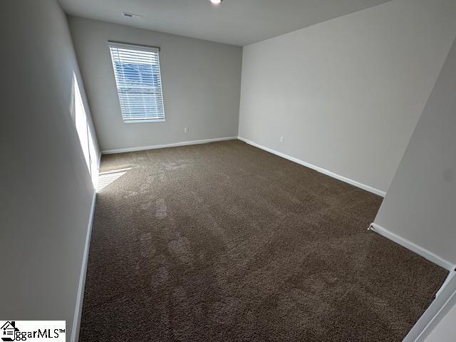 empty room with dark carpet