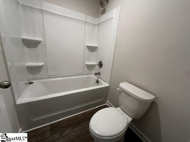 bathroom with toilet and shower / bath combination