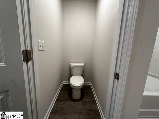 bathroom featuring hardwood / wood-style floors and toilet