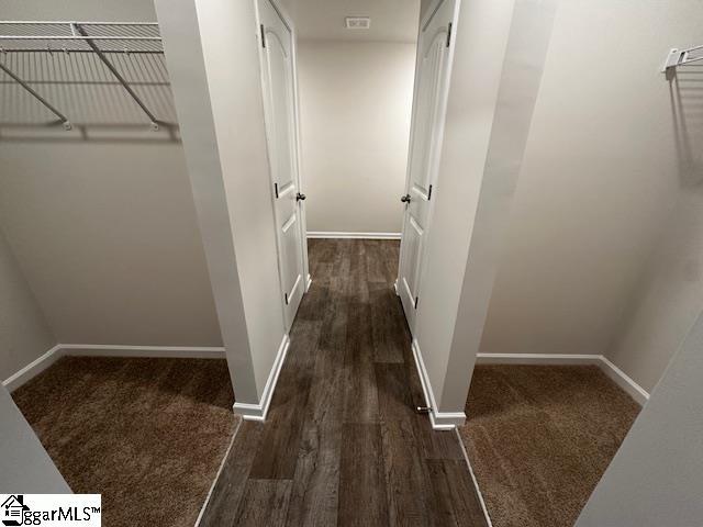 corridor with dark wood-type flooring