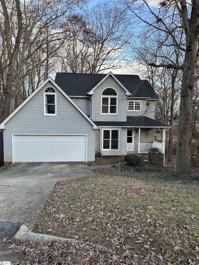 front of property featuring a porch and a garage