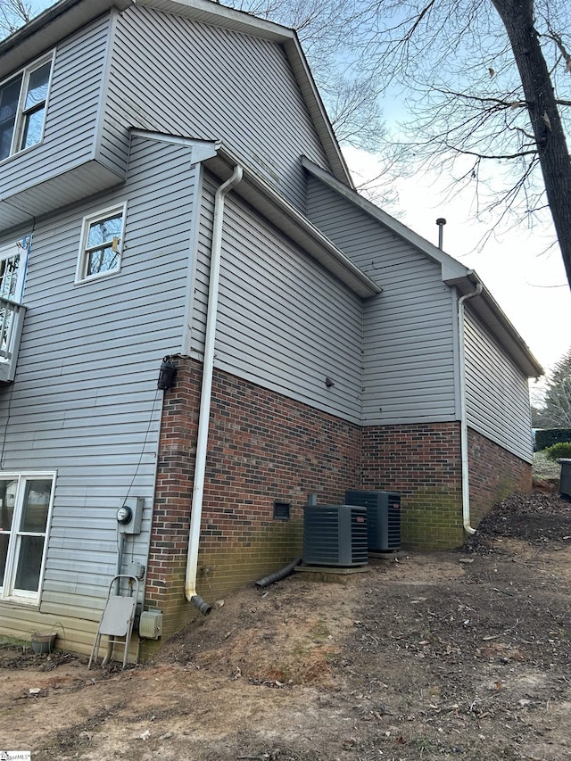 view of side of property with central AC