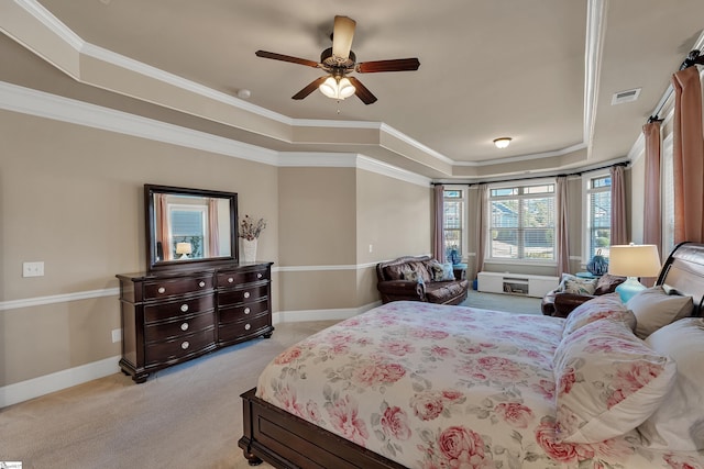 bedroom featuring crown molding, light colored carpet, a raised ceiling, and ceiling fan