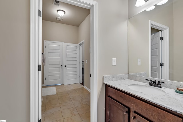 bathroom with tile patterned flooring and vanity