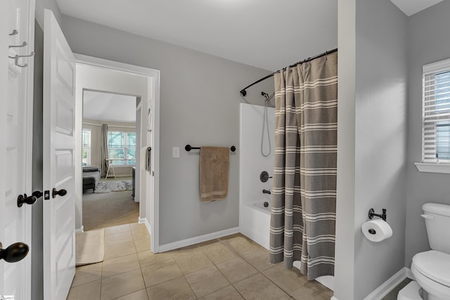 bathroom with toilet, tile patterned flooring, and shower / tub combo