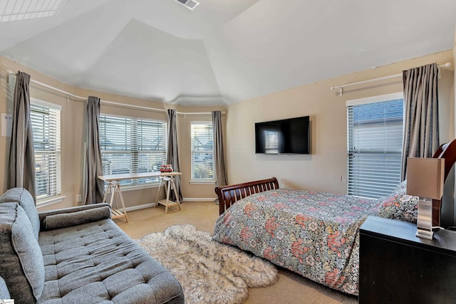 bedroom with multiple windows, vaulted ceiling, and light carpet